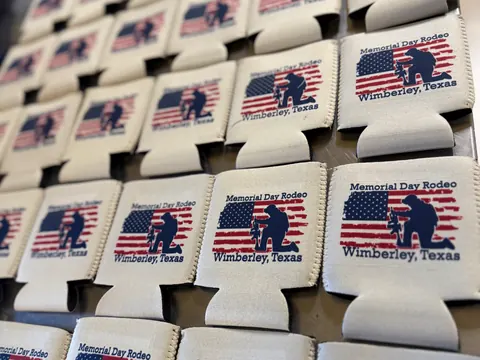 Custom promotional swag — pens, koozies, stickers